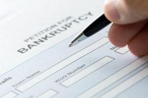 Close up of a person filling petition of bankruptcy form